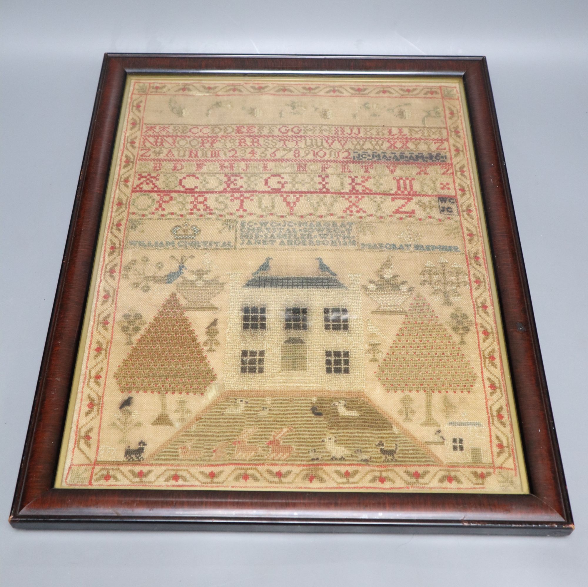 A framed George III sampler, dated 1818, 43 x 33cm, framed